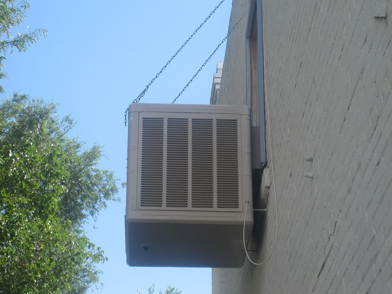 Evaporative air cooler mounted on a window